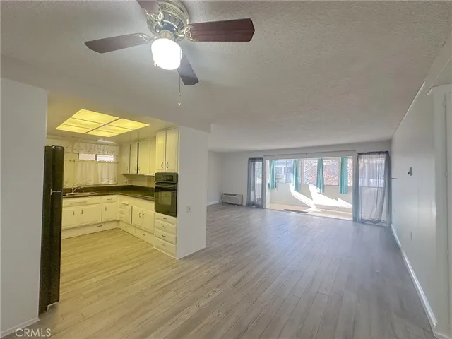 a view of a kitchen with a refrigerator and a window