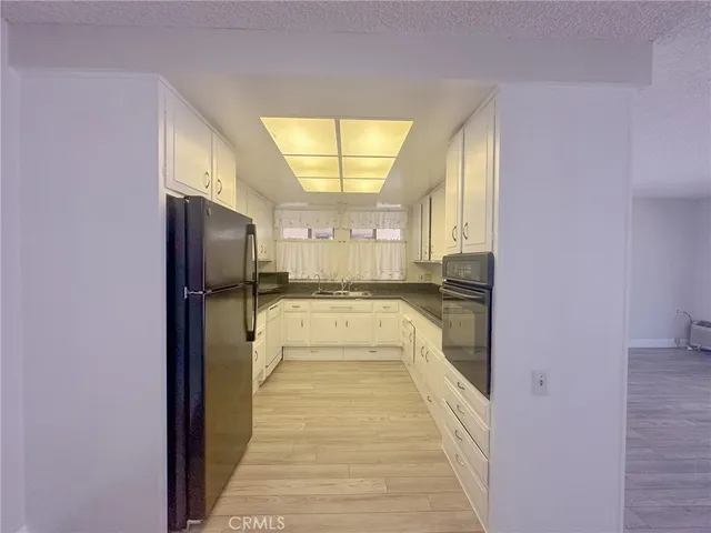 a large white kitchen with a stove and refrigerator