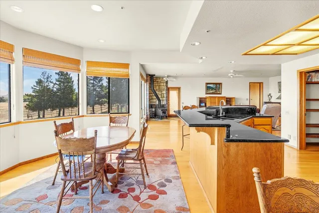 a spacious bedroom with a bed and wooden floor