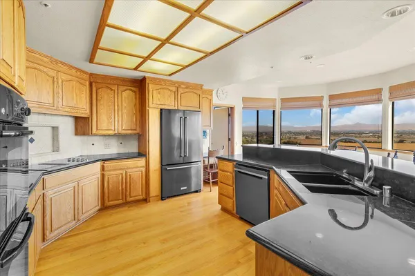 a spacious bathroom with a granite countertop sink mirror and bathtub