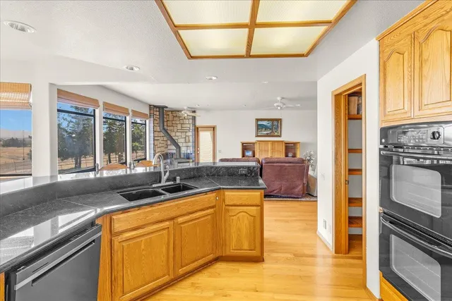 a spacious bedroom with a bed and wooden floor