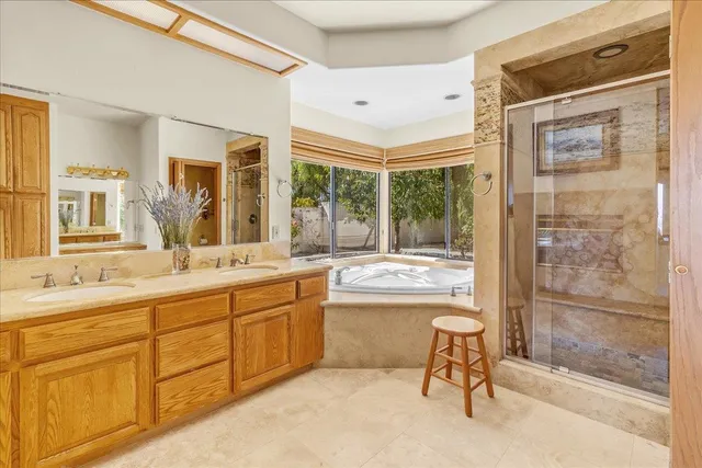 a bedroom with a bed and a dresser next to a window