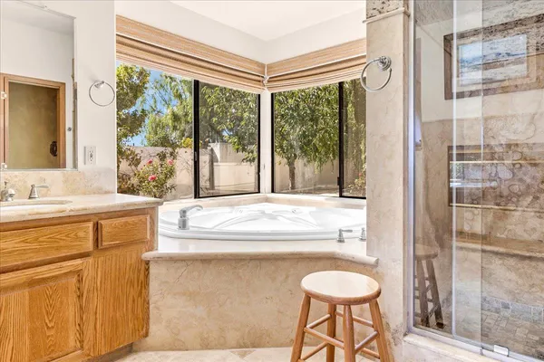 a spacious bedroom with a bed and a dresser in it