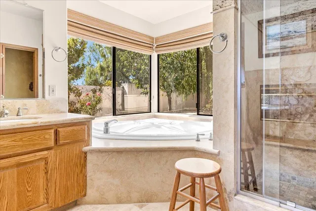 a spacious bedroom with a bed and a dresser in it