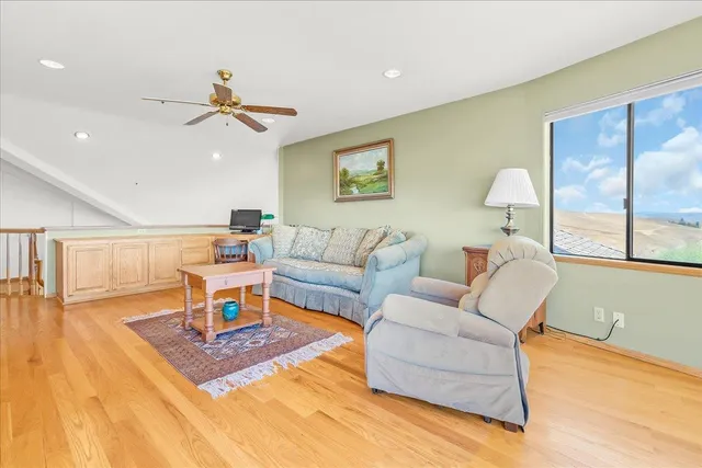 a view of a patio with table and chairs potted plants and large tree