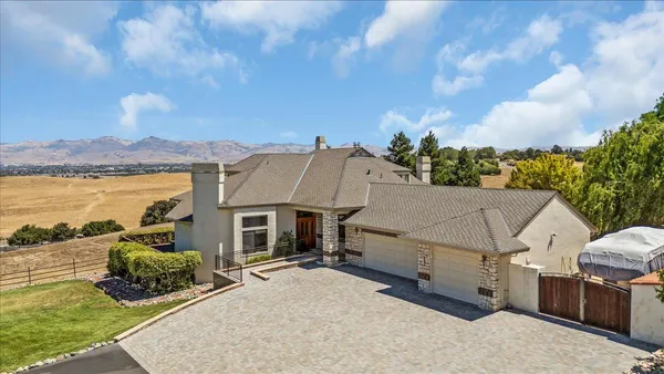 a view of a house with a wooden fence
