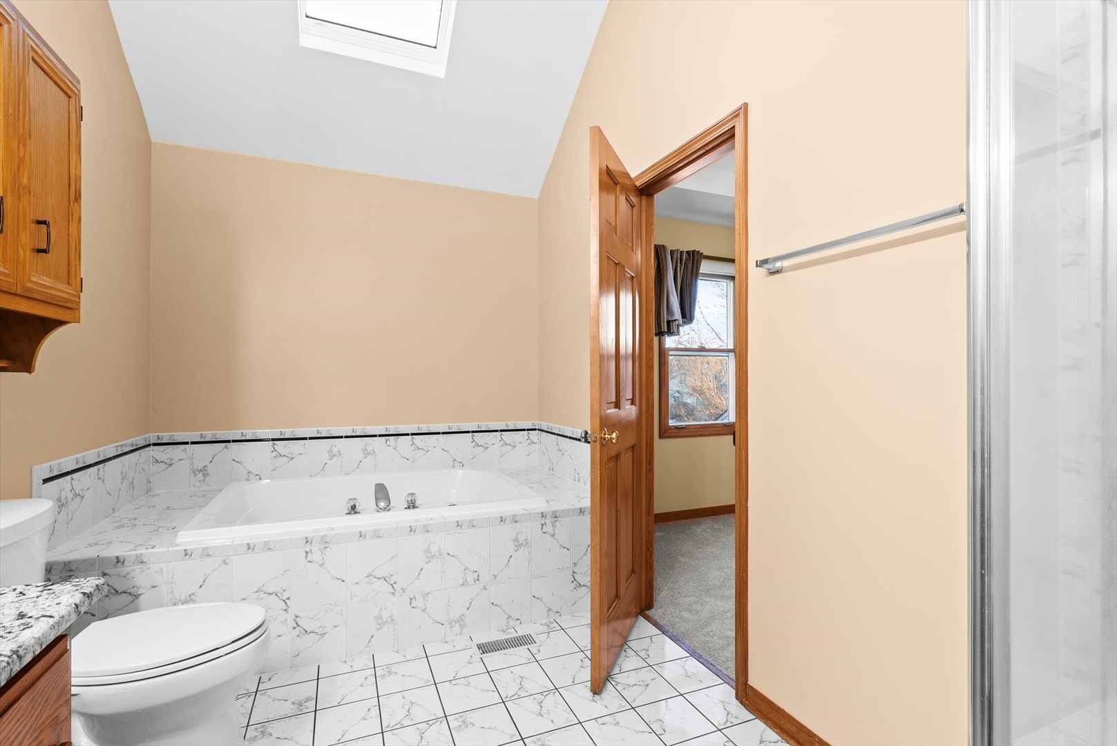 1107 Conan Doyle Road Naperville, IL 60564 - Photo 22 of 34 a bathroom with a bathtub and a toilet