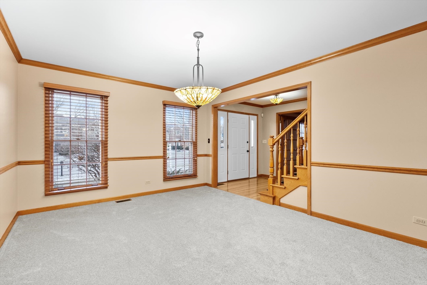 1107 Conan Doyle Road Naperville, IL 60564 - Photo 3 of 34 en empty room with windows and chandelier