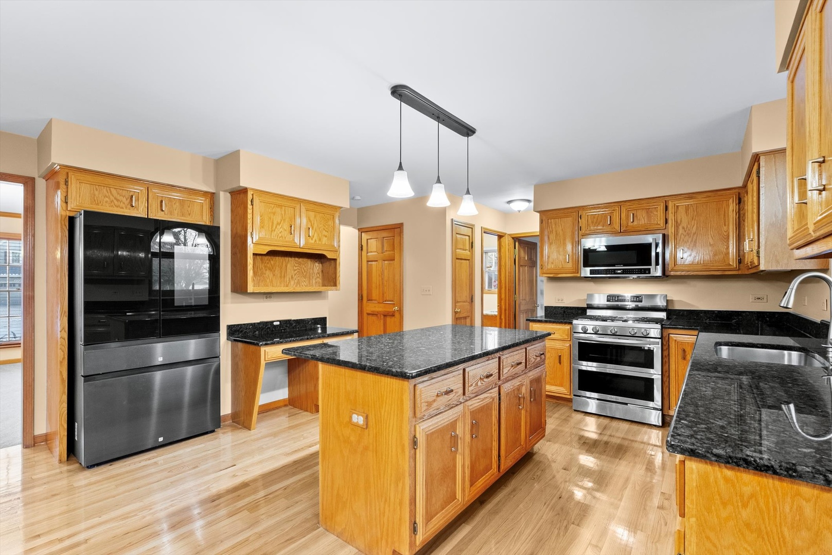 1107 Conan Doyle Road Naperville, IL 60564 - Photo 9 of 34 a kitchen with stainless steel appliances granite countertop a refrigerator and a stove top oven