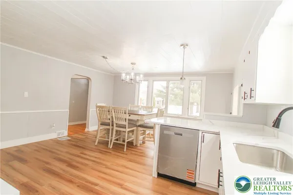 a kitchen with granite countertop a stove a sink and a dining table with granite countertops