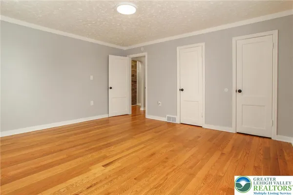 a view of an empty room and wooden floor