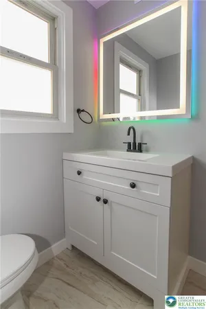 a bathroom with a sink toilet and mirror