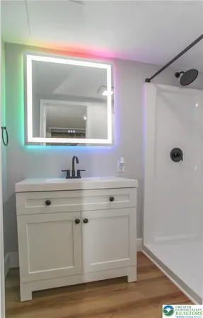 a bathroom with a sink mirror and vanity