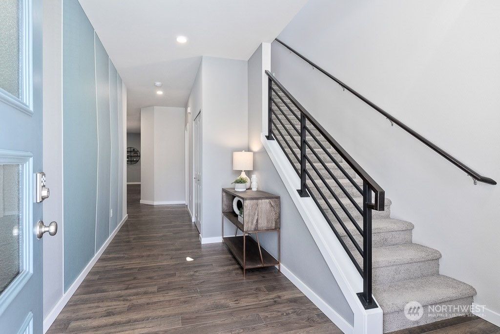 126 177th Street Southeast Bothell, WA 98012 - Photo 2 of 30 a view of a hallway with wooden floor and staircase