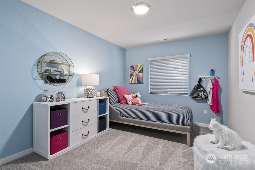 126 177th Street Southeast Bothell, WA 98012 - Photo 27 of 30 a bedroom with a bed and a chandelier