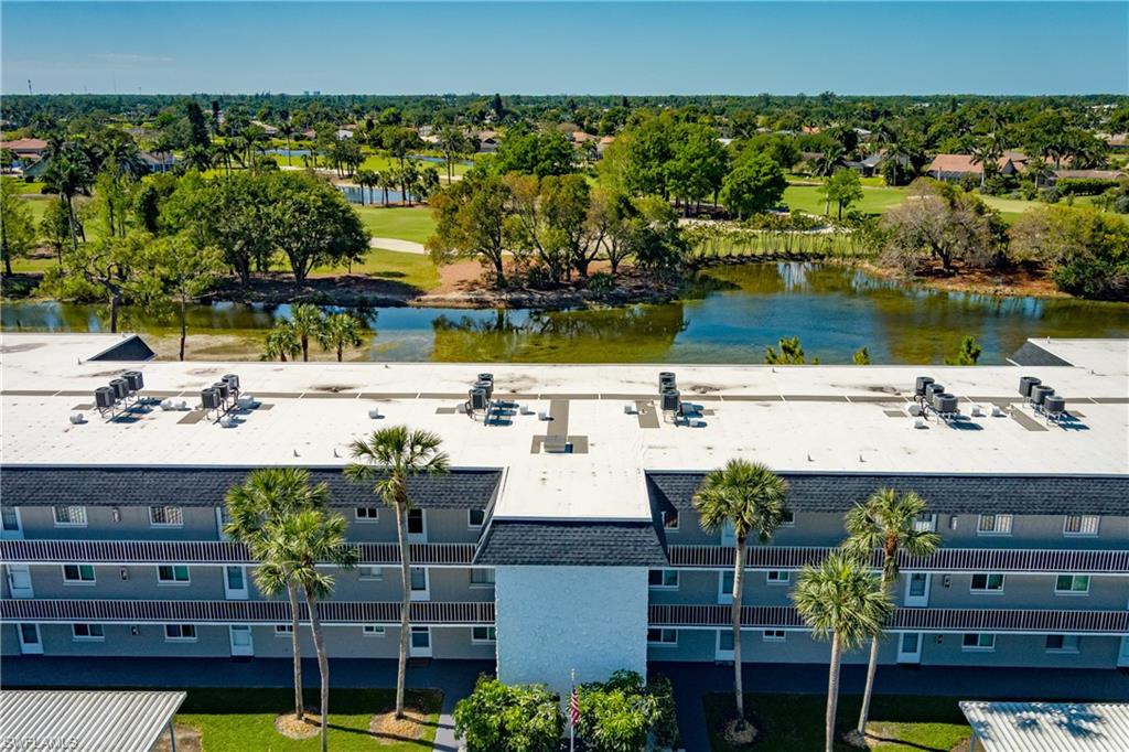 5515 Rattlesnake Hammock Road, Unit 205 Naples, FL 34113 - Photo 27 of 46 Pool featuring fence, a patio area, and outdoor dry bar