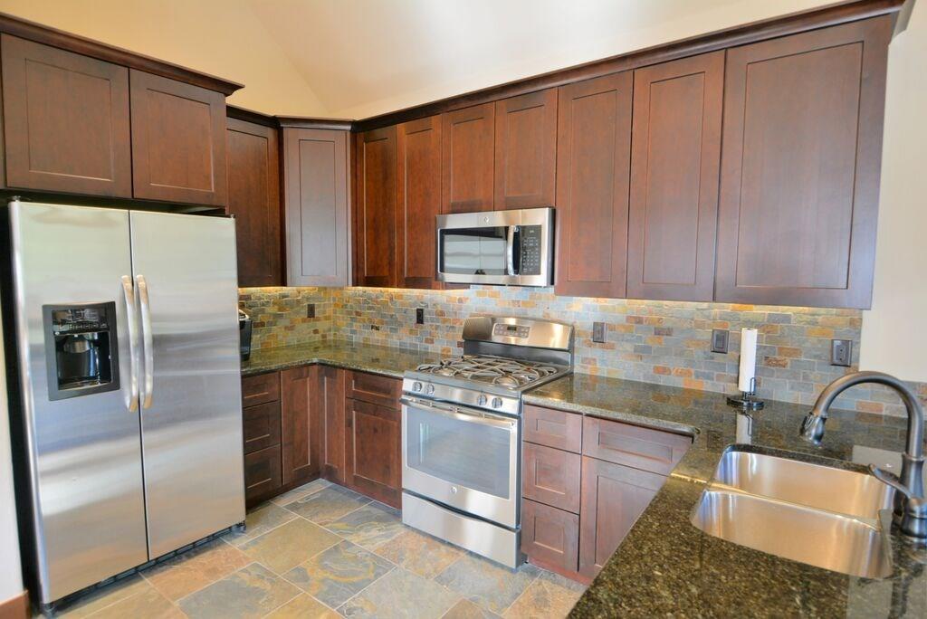 721 Independence Road, Unit 13A Keystone, CO 80435 - Photo 15 of 25 a kitchen with stainless steel appliances granite countertop a sink stove and refrigerator