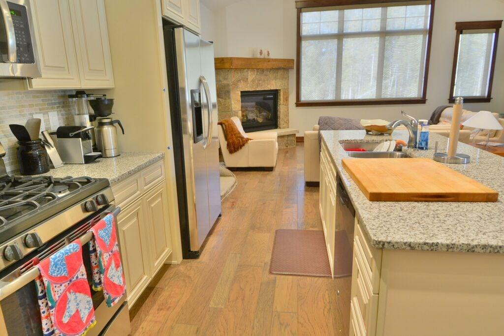 721 Independence Road, Unit 13A Keystone, CO 80435 - Photo 21 of 25 a kitchen with a stove a sink and a refrigerator