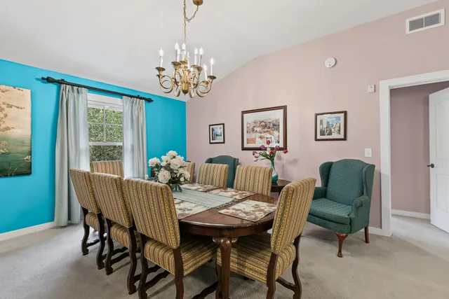 a living room with furniture a flat screen tv and a large window