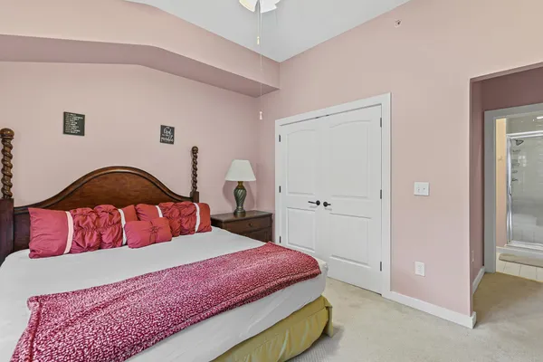 a bedroom with a bed and a large window