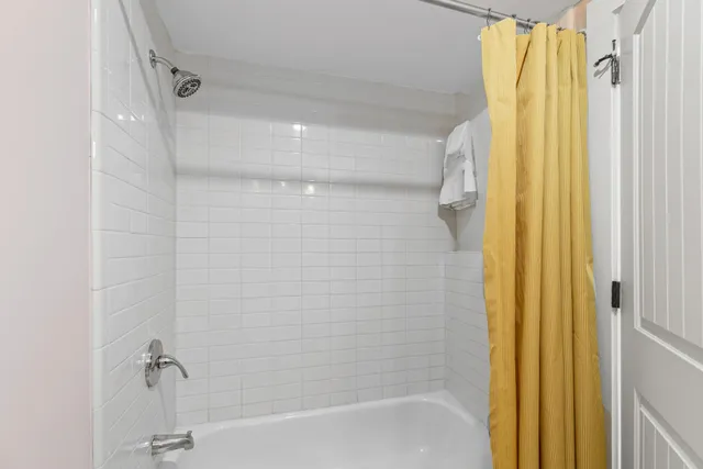 a bedroom with a bed and a lamp