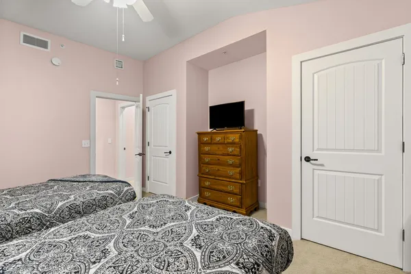 a bedroom with two beds and a window