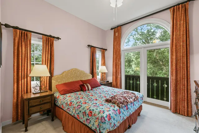 a bedroom with a bed and dresser with mirror