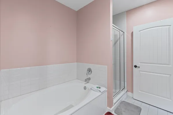a spacious bathroom with a double vanity sink and a mirror