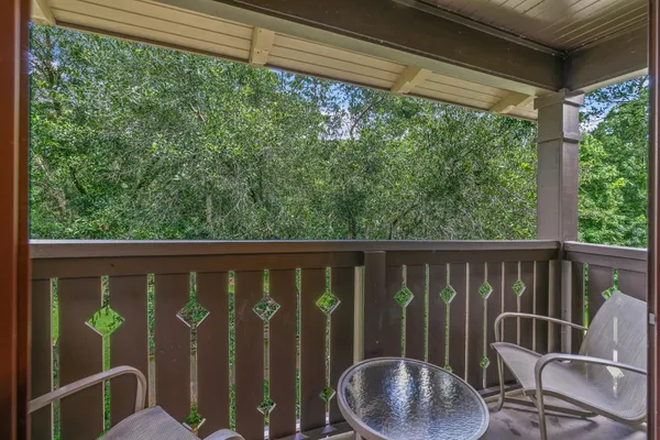 a view of a chair and table in the balcony