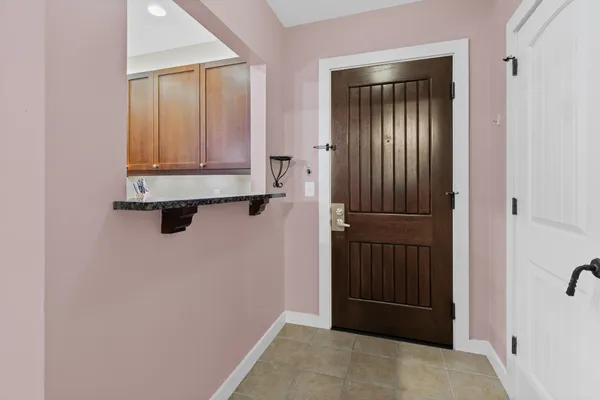 a kitchen with stainless steel appliances granite countertop a sink and a refrigerator