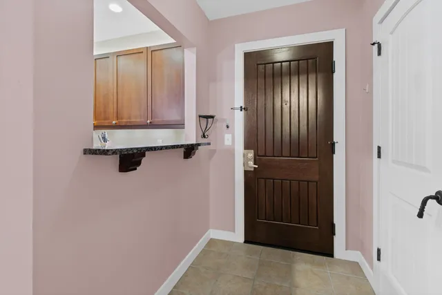 a kitchen with stainless steel appliances granite countertop a sink and a refrigerator