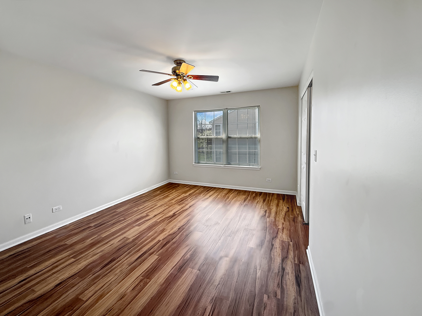 3078 Falling Waters Lane, Unit 3078 Lindenhurst, IL 60046 - Photo 12 of 19 an empty room with windows and chandelier