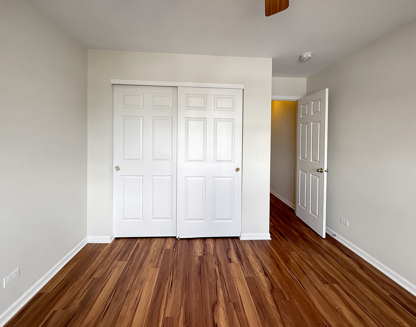 3078 Falling Waters Lane, Unit 3078 Lindenhurst, IL 60046 - Photo 16 of 19 an empty room with wooden floor and closet