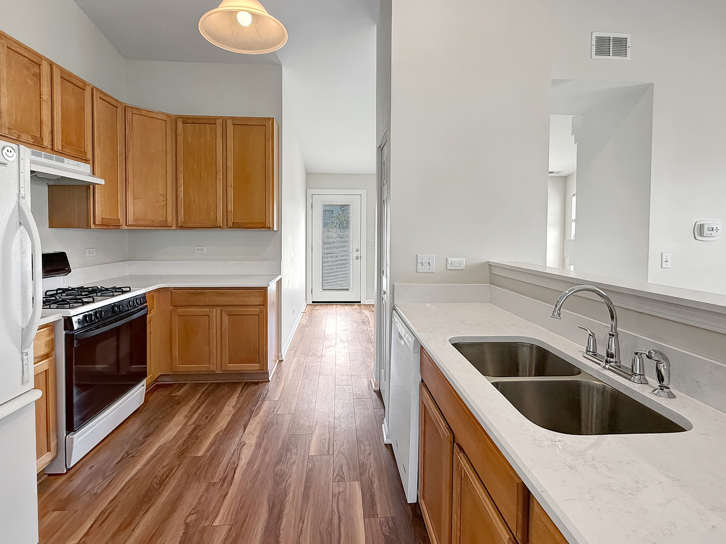 3078 Falling Waters Lane, Unit 3078 Lindenhurst, IL 60046 - Photo 7 of 19 a kitchen with a sink and a stove top oven