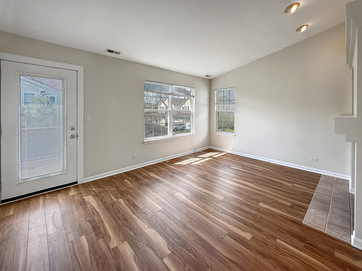 3078 Falling Waters Lane, Unit 3078 Lindenhurst, IL 60046 - Photo 9 of 19 an empty room with wooden floor and windows
