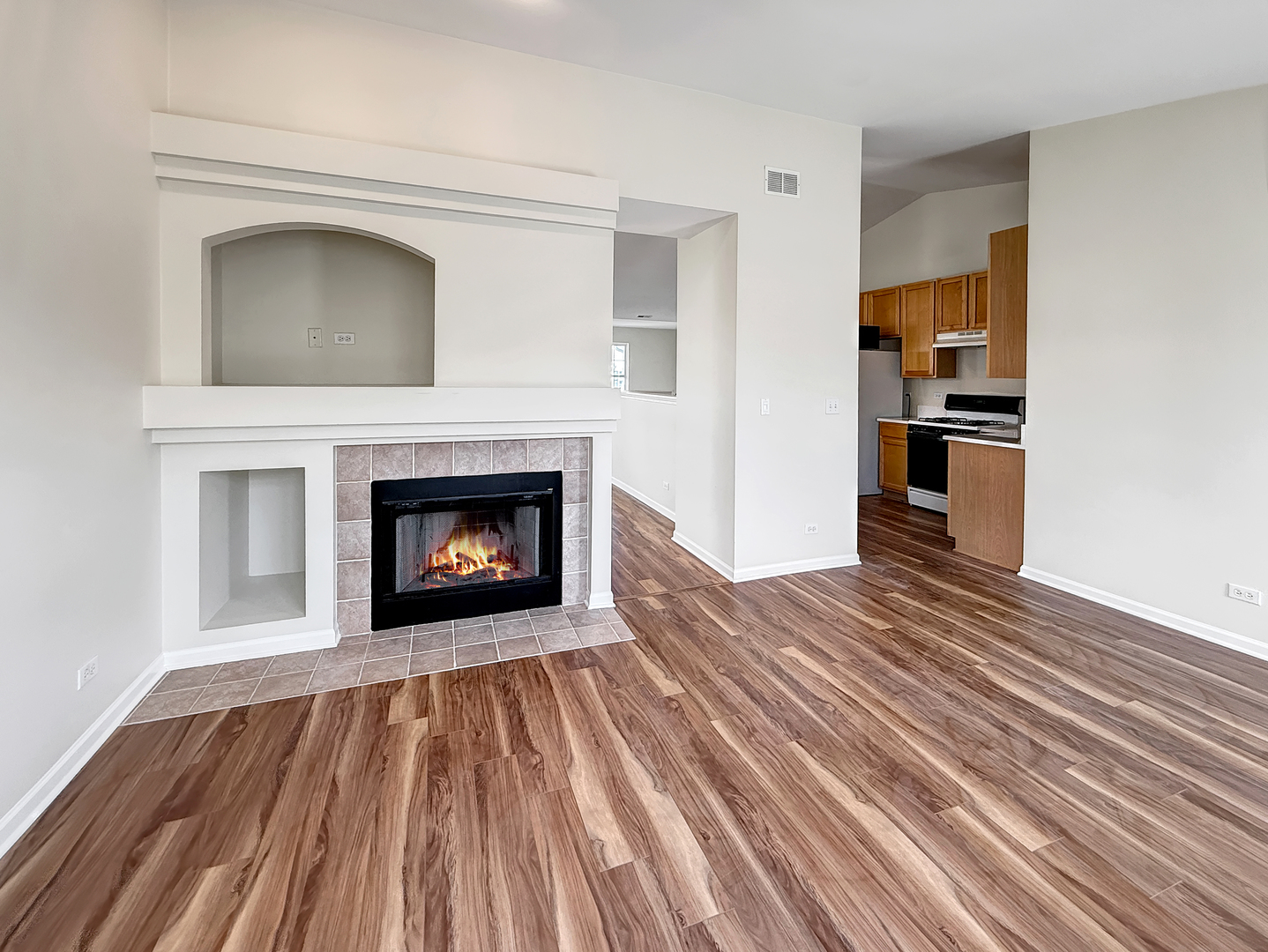 3078 Falling Waters Lane, Unit 3078 Lindenhurst, IL 60046 - Photo 10 of 19 a view of a livingroom with wooden floor and a fireplace