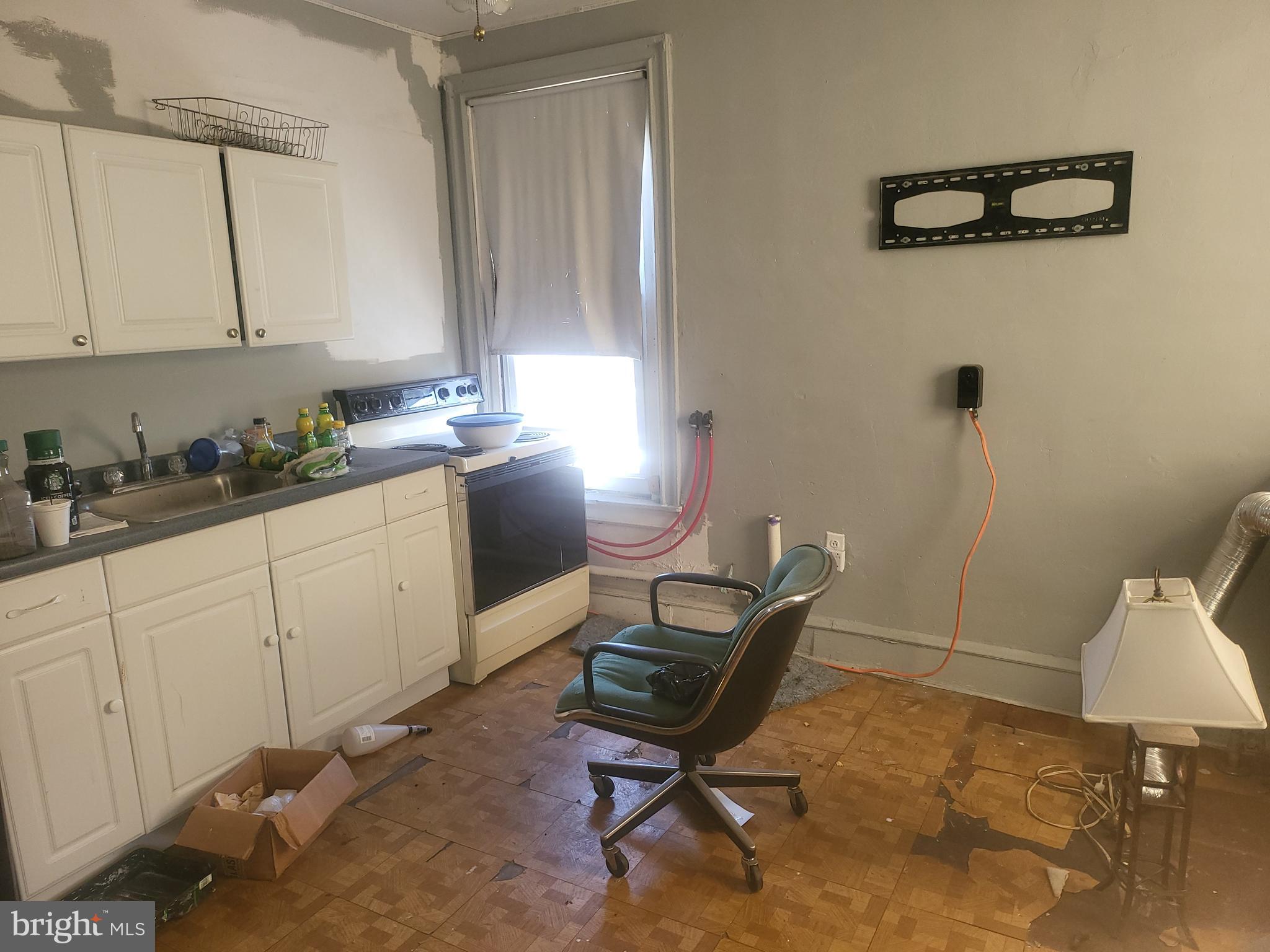 5700 Delancey Street Philadelphia, PA 19143 - Photo 11 of 12 a kitchen with a sink cabinets and appliances