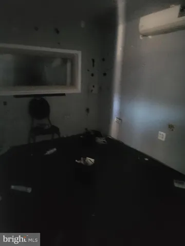 a living room with a chair and a fireplace