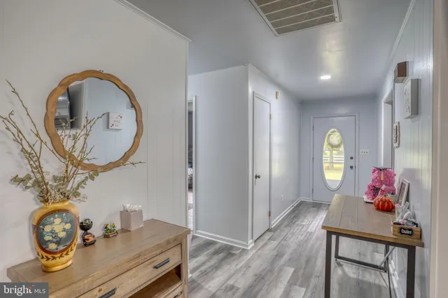 a view of bathroom with a table and a mirror