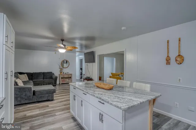 a living room with granite countertop furniture and fireplace