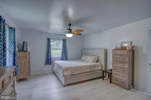 a bedroom with a bed and a television