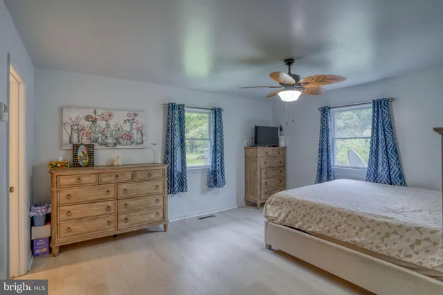 a bedroom with a large bed and a chandelier