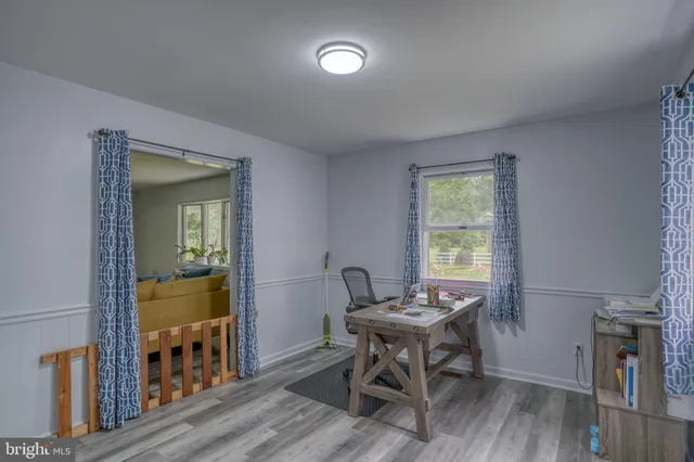 a workspace with furniture window and wooden floor