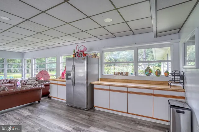 a kitchen with stainless steel appliances granite countertop a refrigerator and a sink