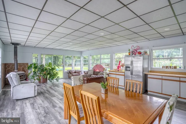 a dining room with furniture water view and a large window