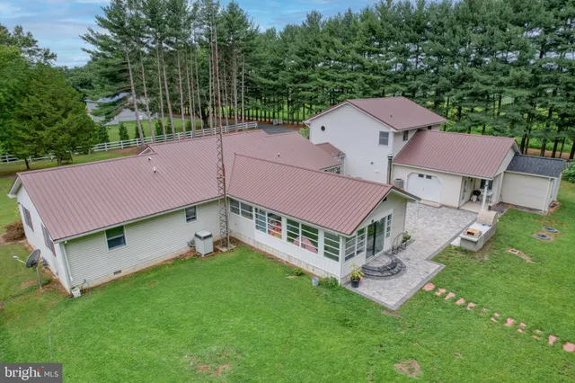 a aerial view of a house with a big yard and large trees