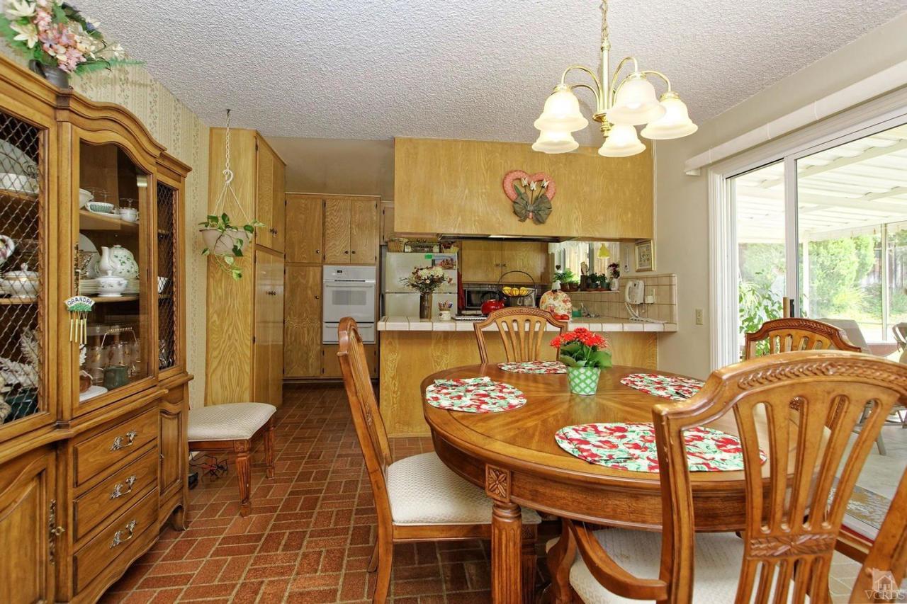 5414 Parkmor Road Calabasas, CA 91302 - Photo 27 of 58 a view of a dining room with furniture a chandelier and large windows