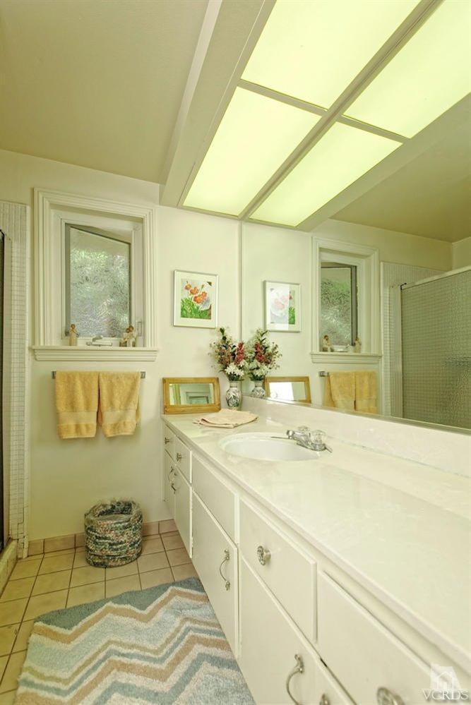 5414 Parkmor Road Calabasas, CA 91302 - Photo 31 of 58 a spacious bathroom with a double vanity sink and a mirror