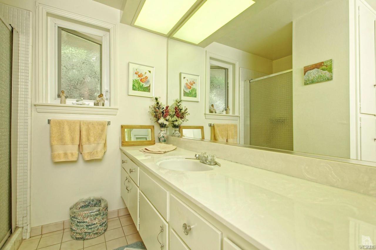 5414 Parkmor Road Calabasas, CA 91302 - Photo 32 of 58 a bathroom with a sink and a mirror