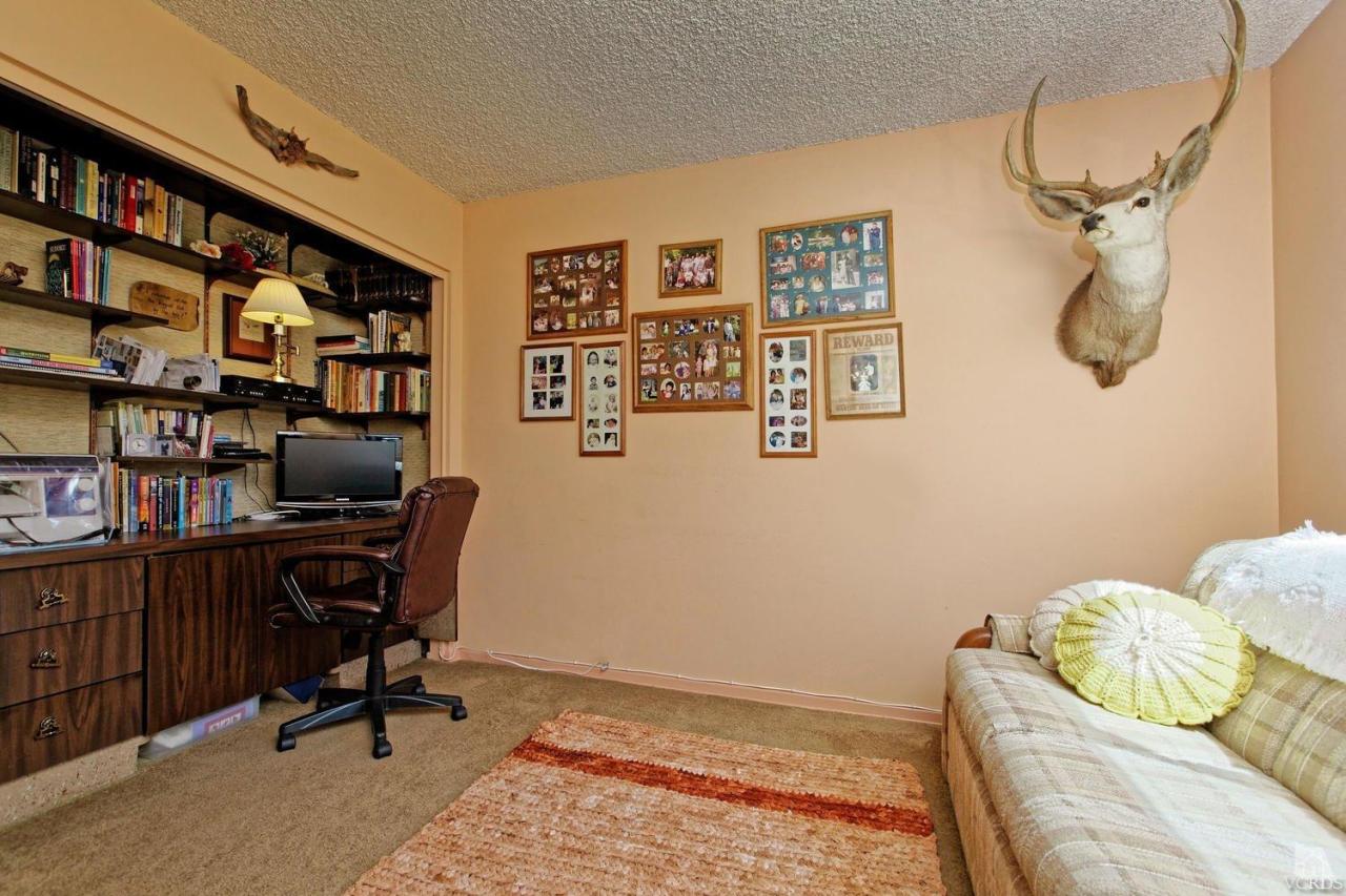 5414 Parkmor Road Calabasas, CA 91302 - Photo 35 of 58 a view of a workspace with furniture and a bookshelf